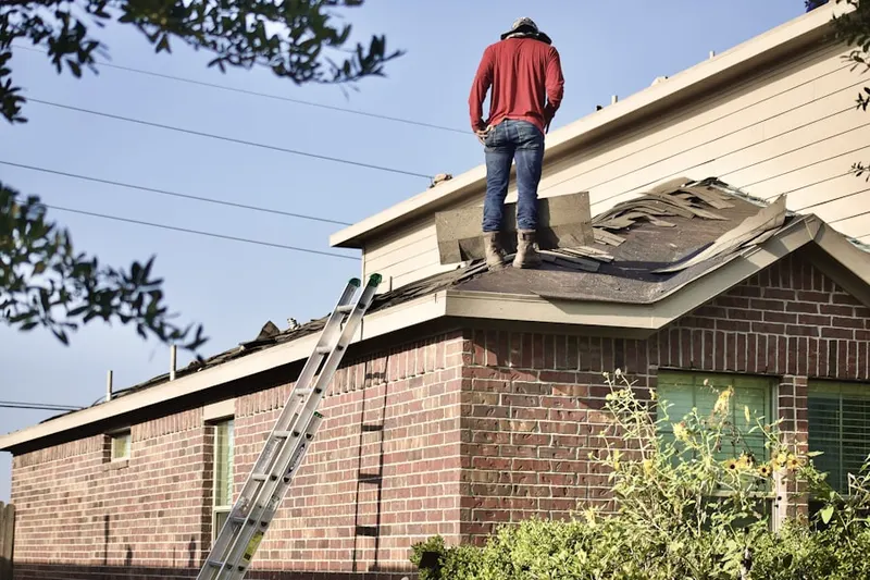 Professional roofer working on a residential roof in Reidville